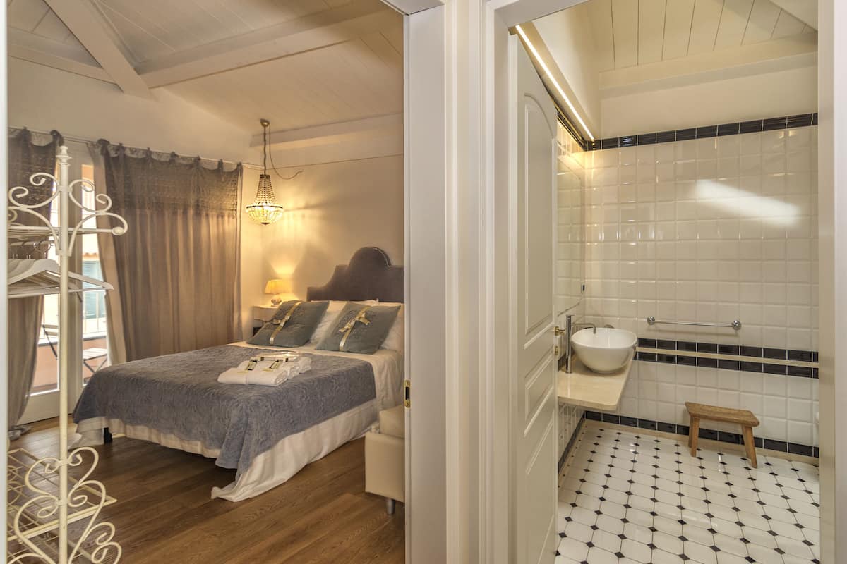 Une chambre à coucher avec un lit, une table de chevet, une lampe et un luminaire suspendu.