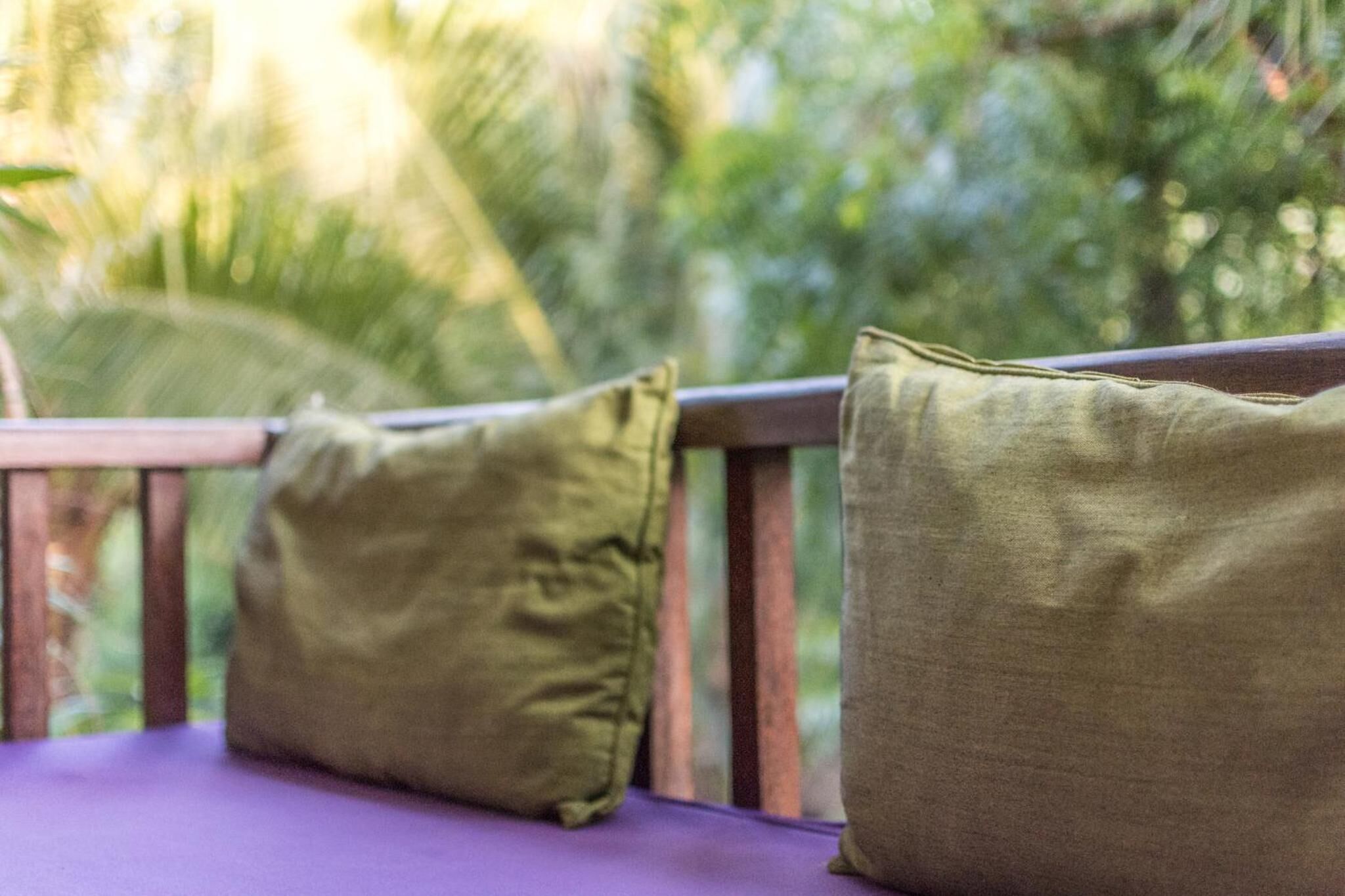 A wooden deck with two cushions.