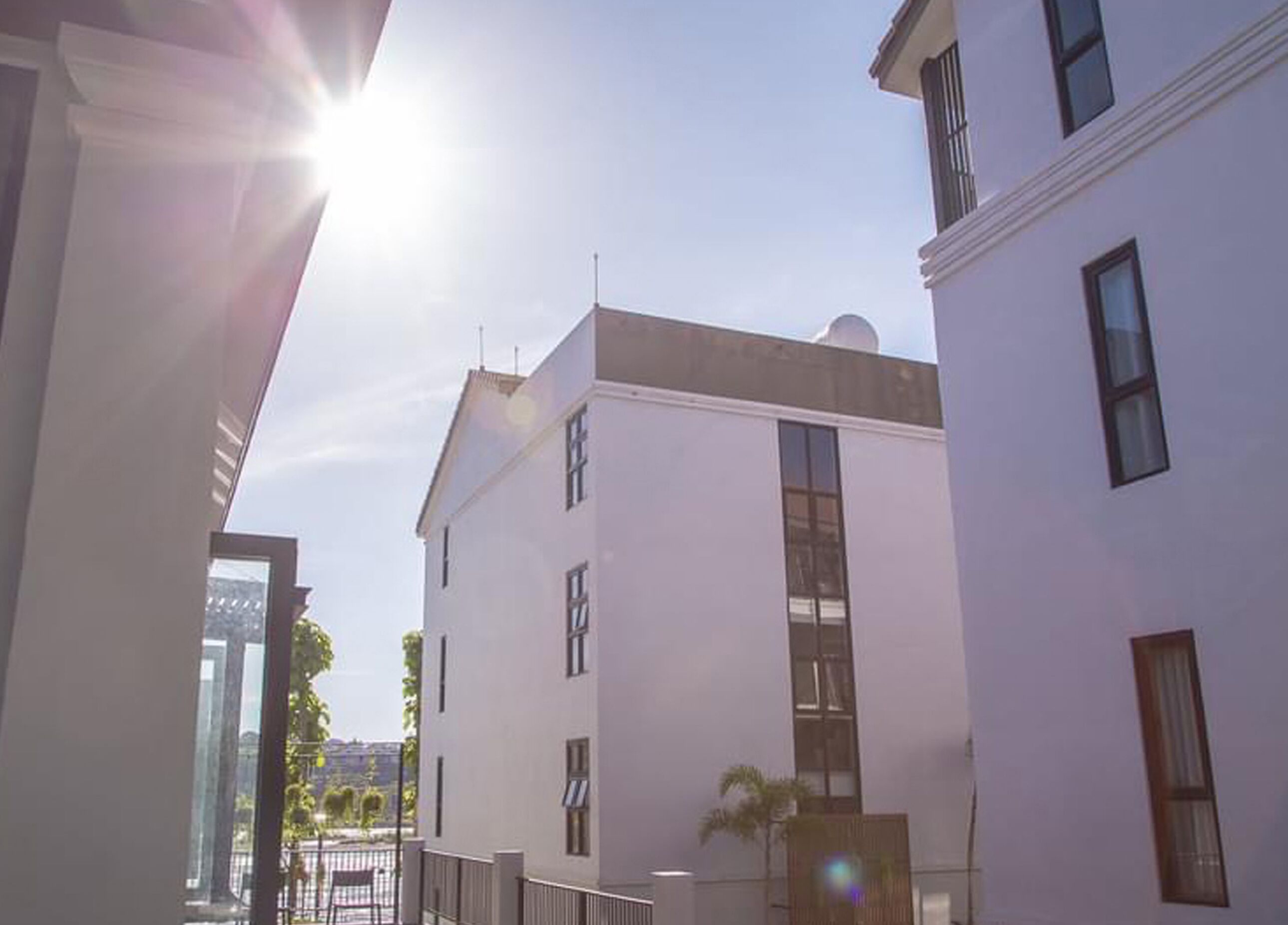 A white building with multiple windows and a balcony.