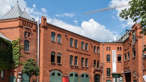 A historic red brick building with arched windows and green doors, likely a museum or cultural site. - Pension Freiraum Guesthouse Berlin (Berlin)