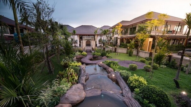 A resort with a central water feature, lush landscaping, and multiple buildings with a consistent architectural style. - Maryo Resort Chiangrai (Chiang Rai)