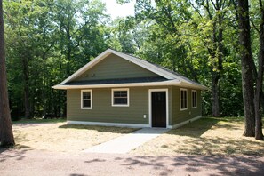 A small, single-story house with a gabled roof, a front door, and two windows. - Mission Springs Resort (Ashland)