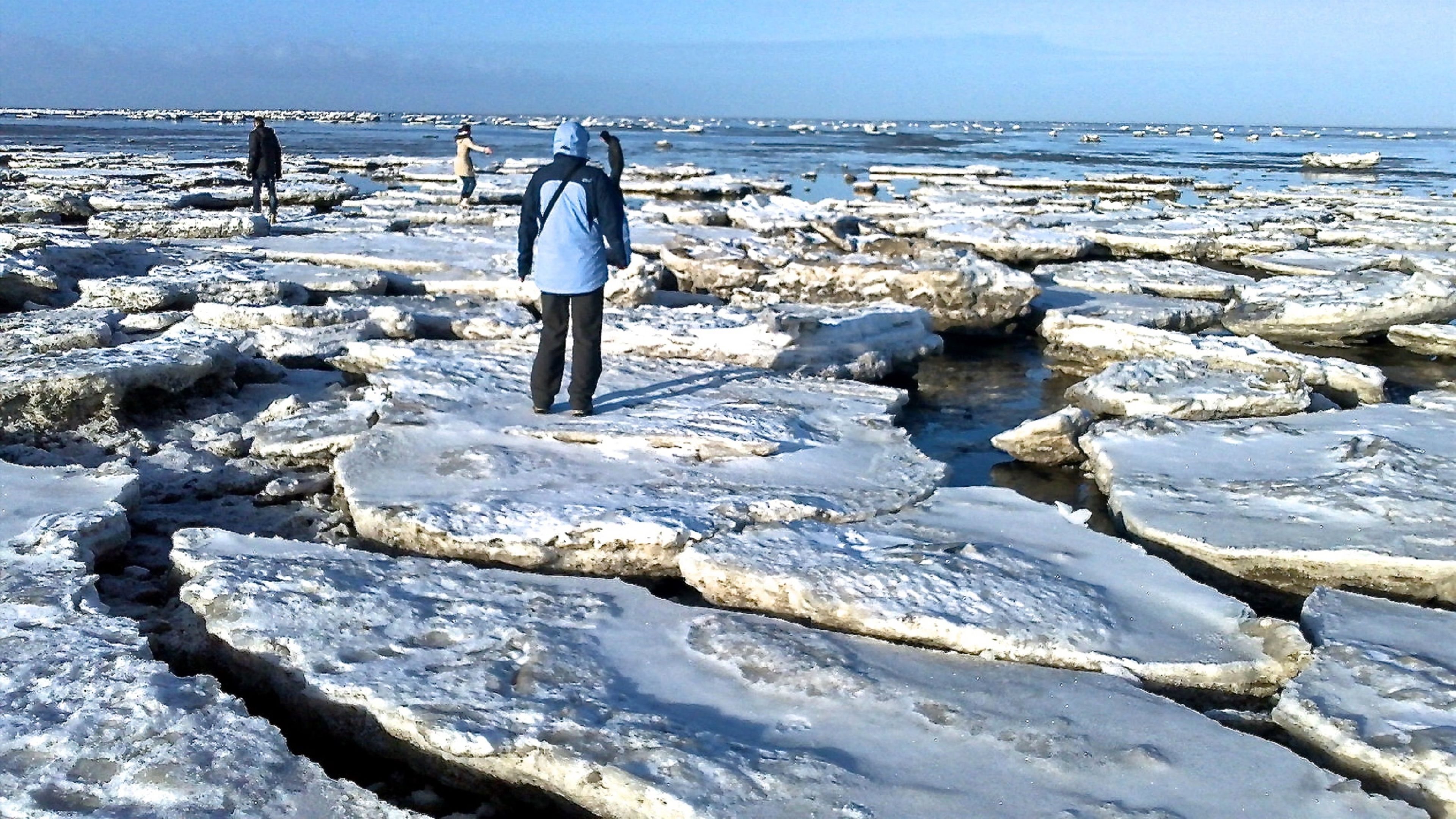 A rocky beach with large ice formations.