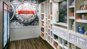 A snack display area with shelves stocked with various treats and a chalkboard with motivational writing. - Hampton Inn & Suites Mason City (Mason City)