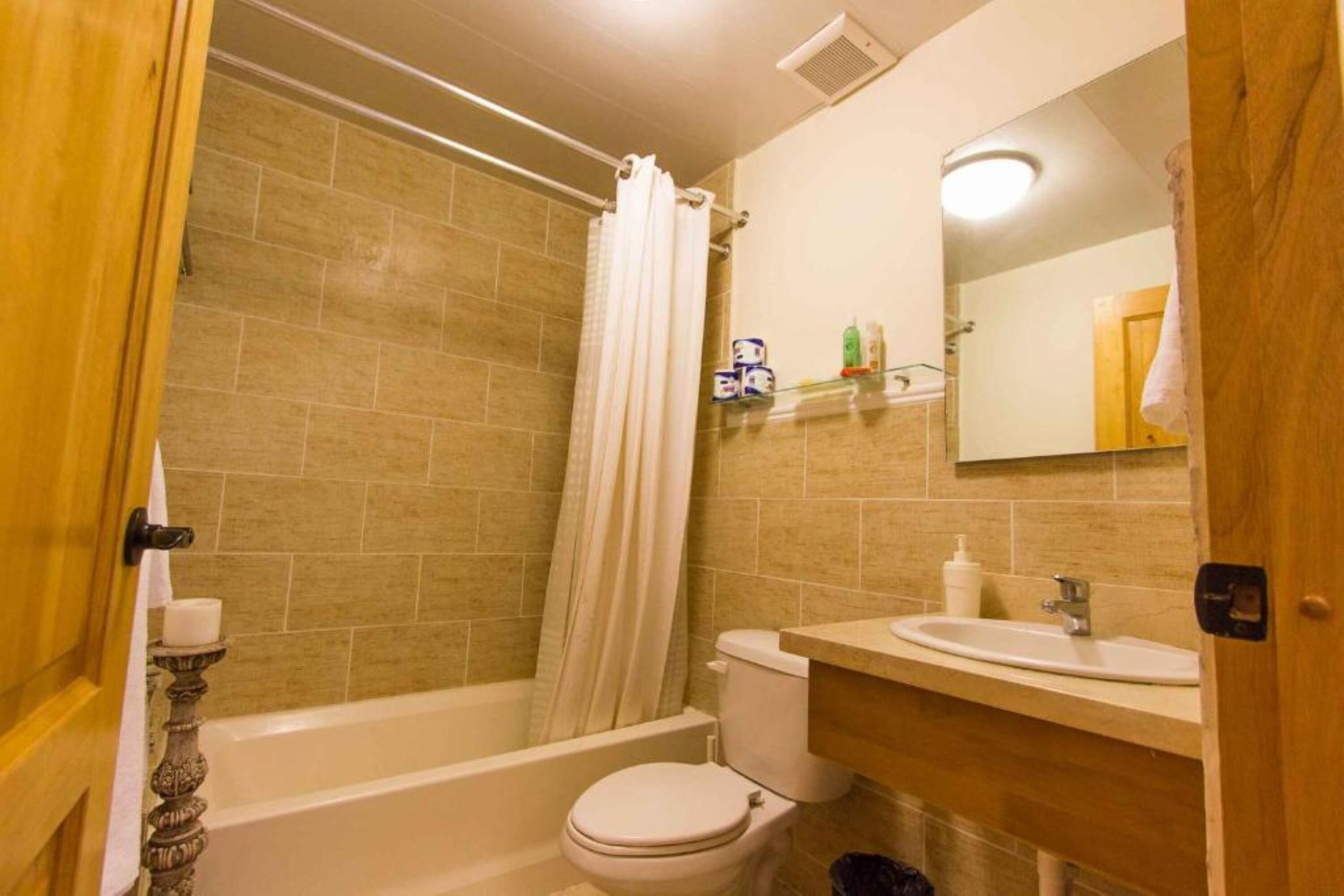 A bathroom with a bathtub, toilet, and sink.
