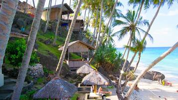 On the beach, white sand, sun loungers, beach umbrellas
