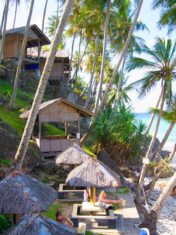 On the beach, white sand, sun loungers, beach umbrellas