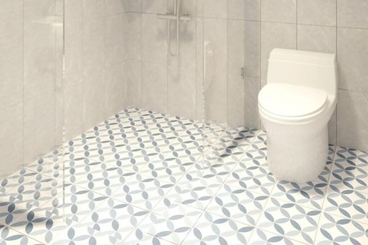 A bathroom with a shower, toilet, and a window.