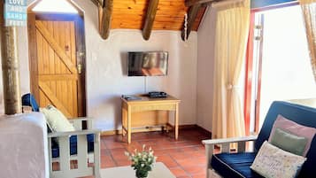 The Villa - Self Catering | Living area | 65-cm LCD TV with satellite channels, TV, Netflix