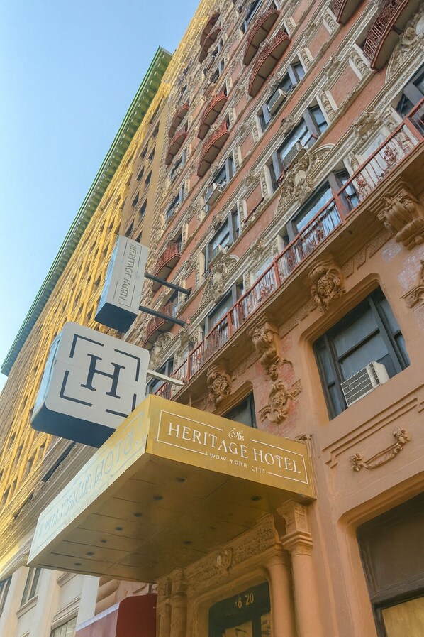A Heritage Hotel with ornate architectural details, including balconies with red railings and decorative stonework. - Heritage Hotel (New York)