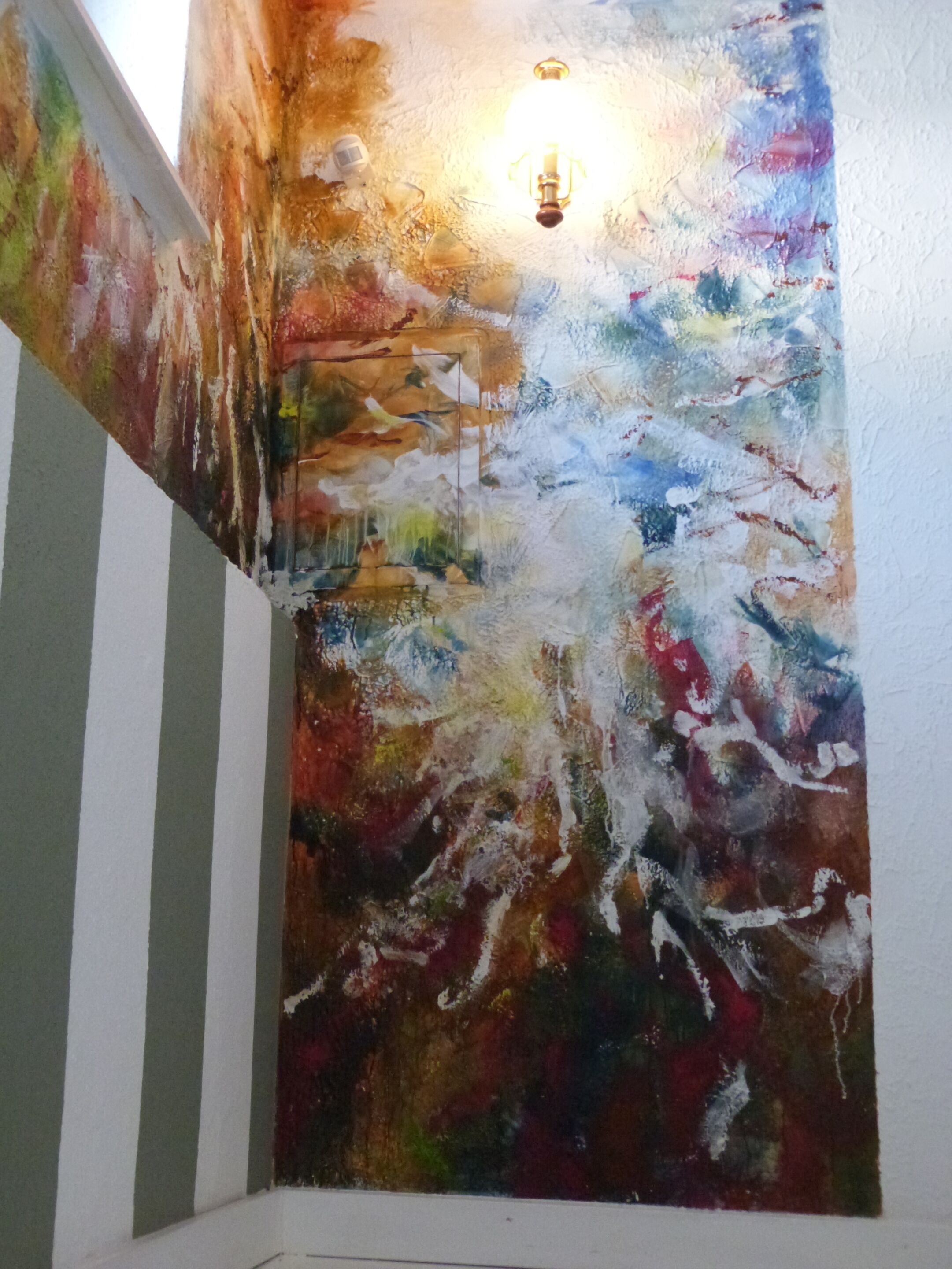 A textured wall with a light fixture.