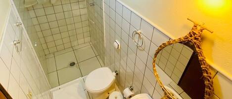 A bathroom with a shower, toilet, and sink.