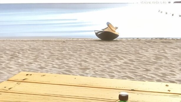 A wooden table with a green bottle on it, a boat on the water, and a sandy beach. - Kstar 888 Bed and Breakfast (Hengchun)