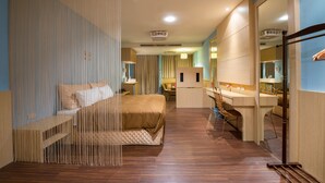A modern hotel room with a large bed, a desk, and a bathroom. - Red Sun (Checheng)