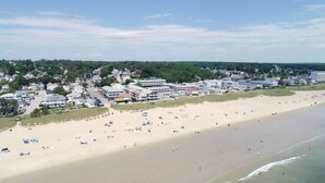 An aerial view of a beach with a row of buildings in the background. - Sea View Inn (Old Orchard Beach)
