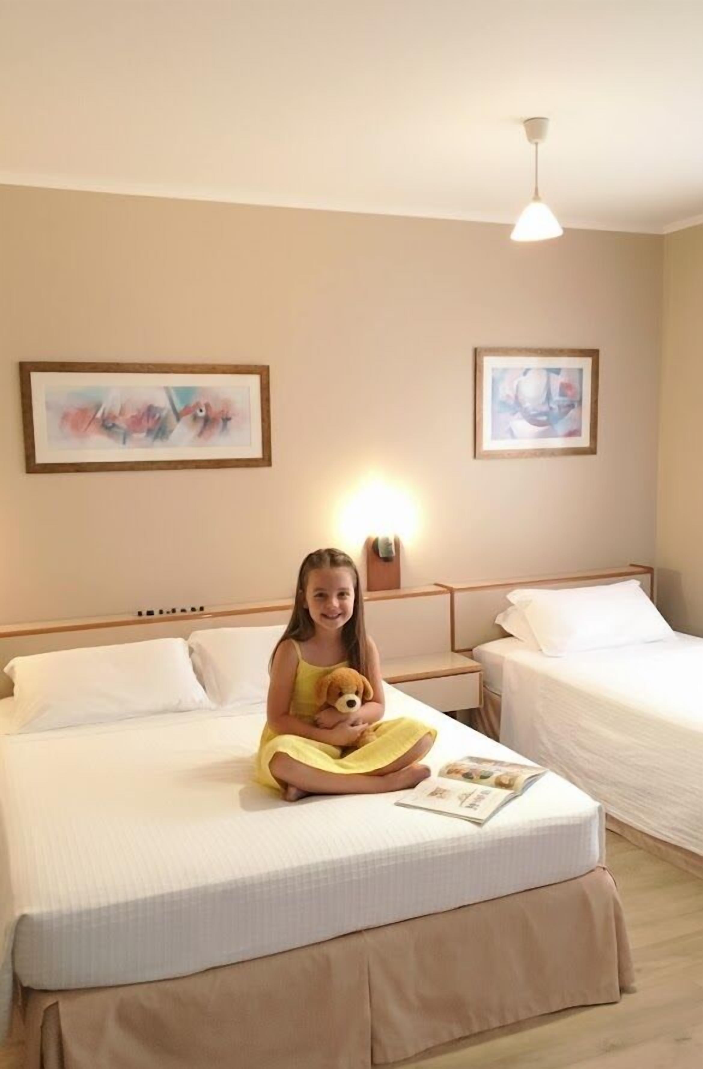 Superior Triple Room | Minibar, in-room safe, individually decorated, desk