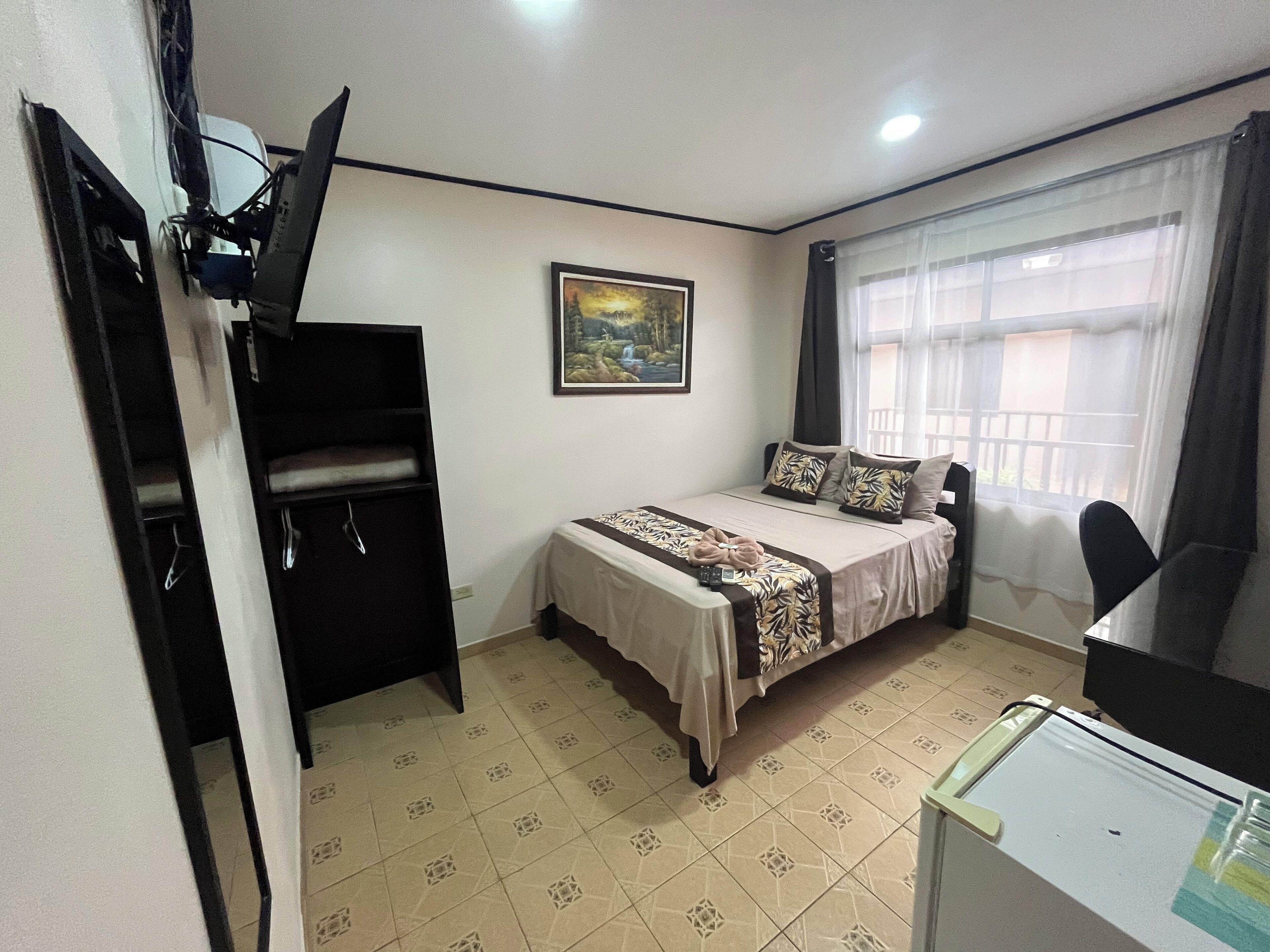single room | premium bedding, desk, laptop workspace, blackout curtains
