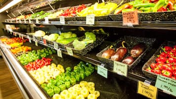 A grocery store's produce section with various vegetables on display.