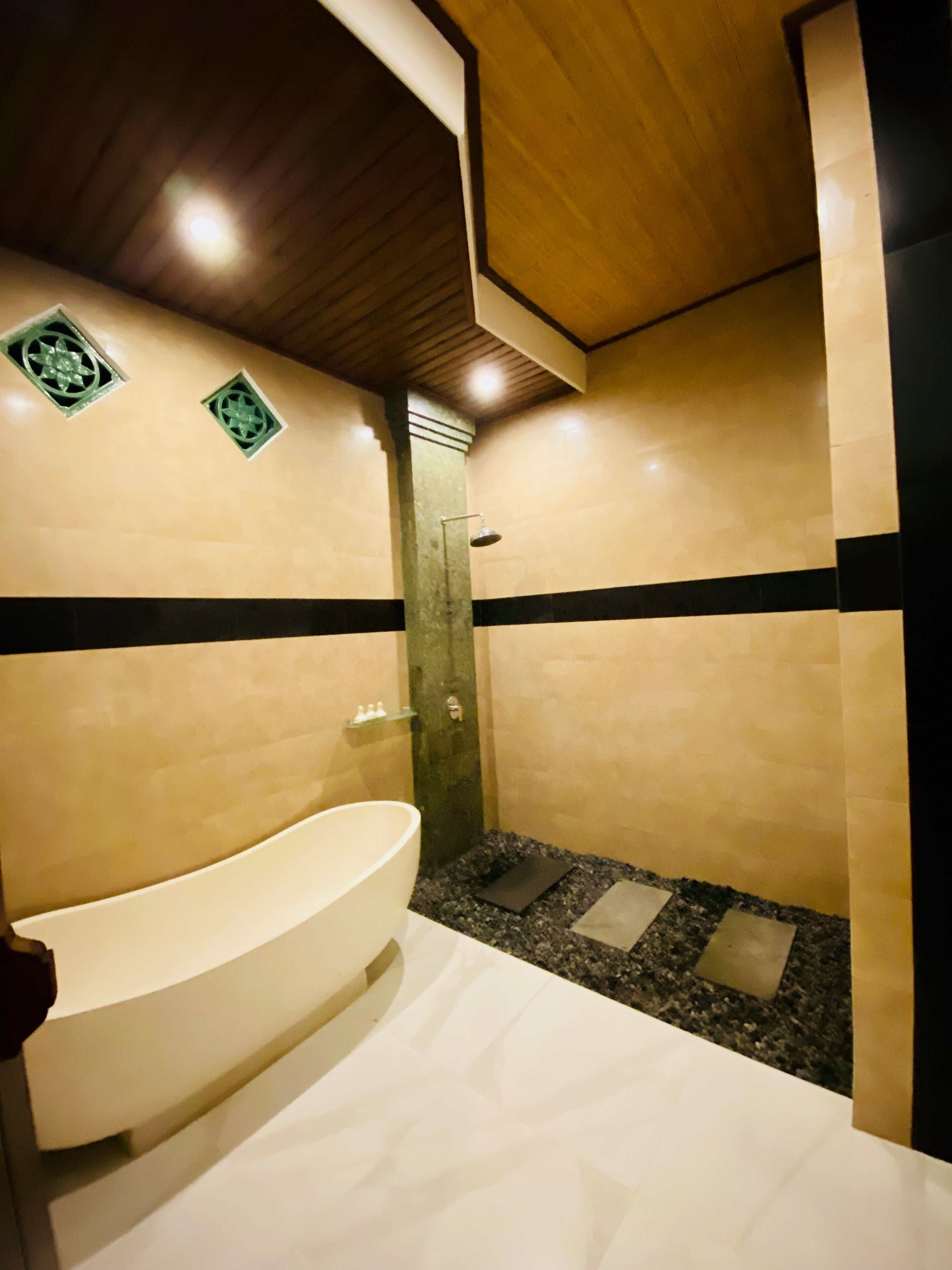 A modern bathroom with a freestanding bathtub, a shower, and a tiled floor.