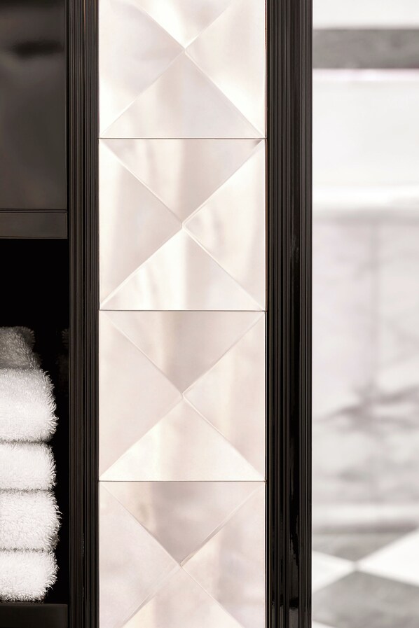 A modern interior with a geometric patterned wall and a black frame. - Baur au Lac (Zürich)