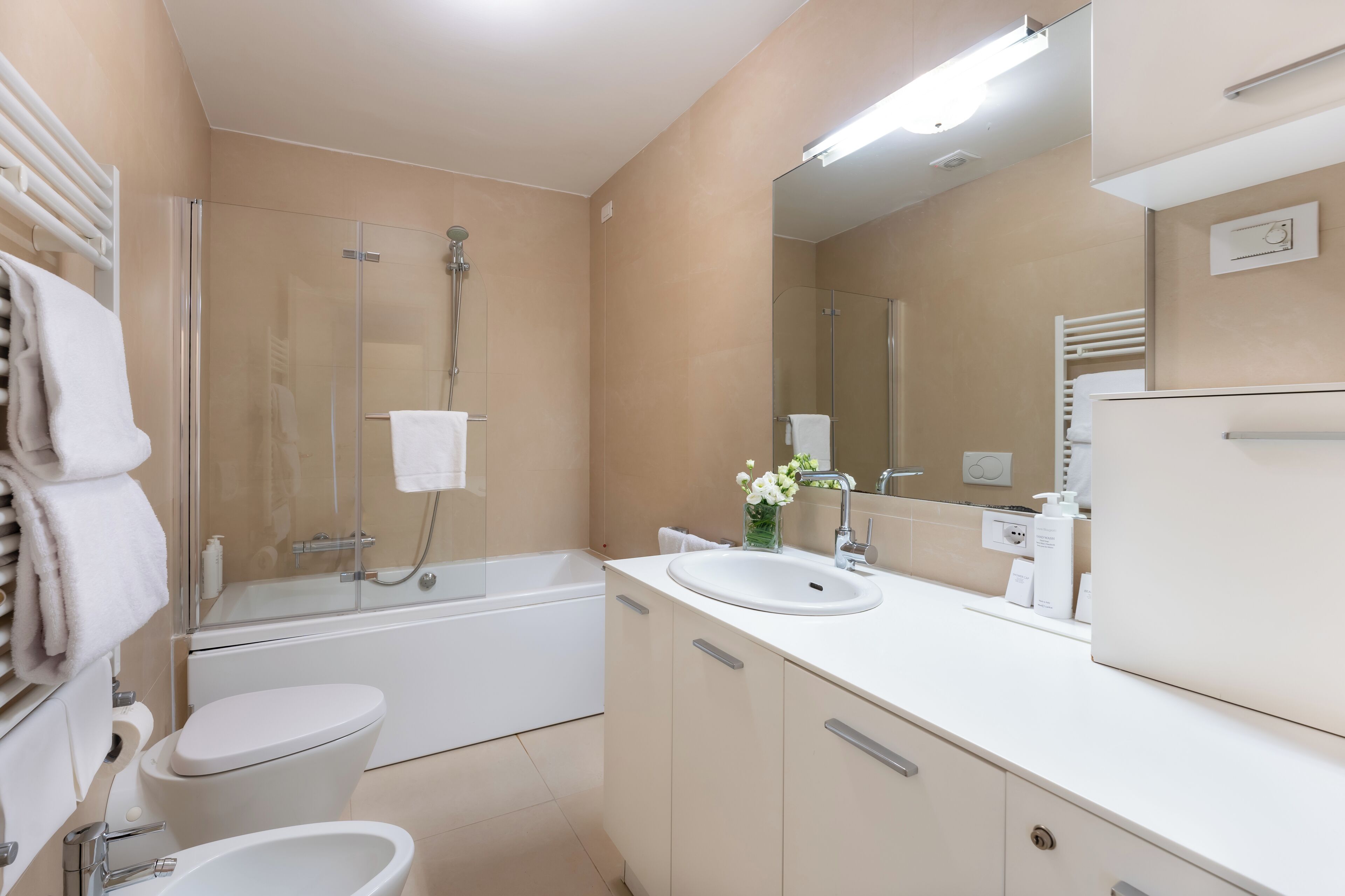 Et moderne badeværelse med badekar, toilet og håndvask.