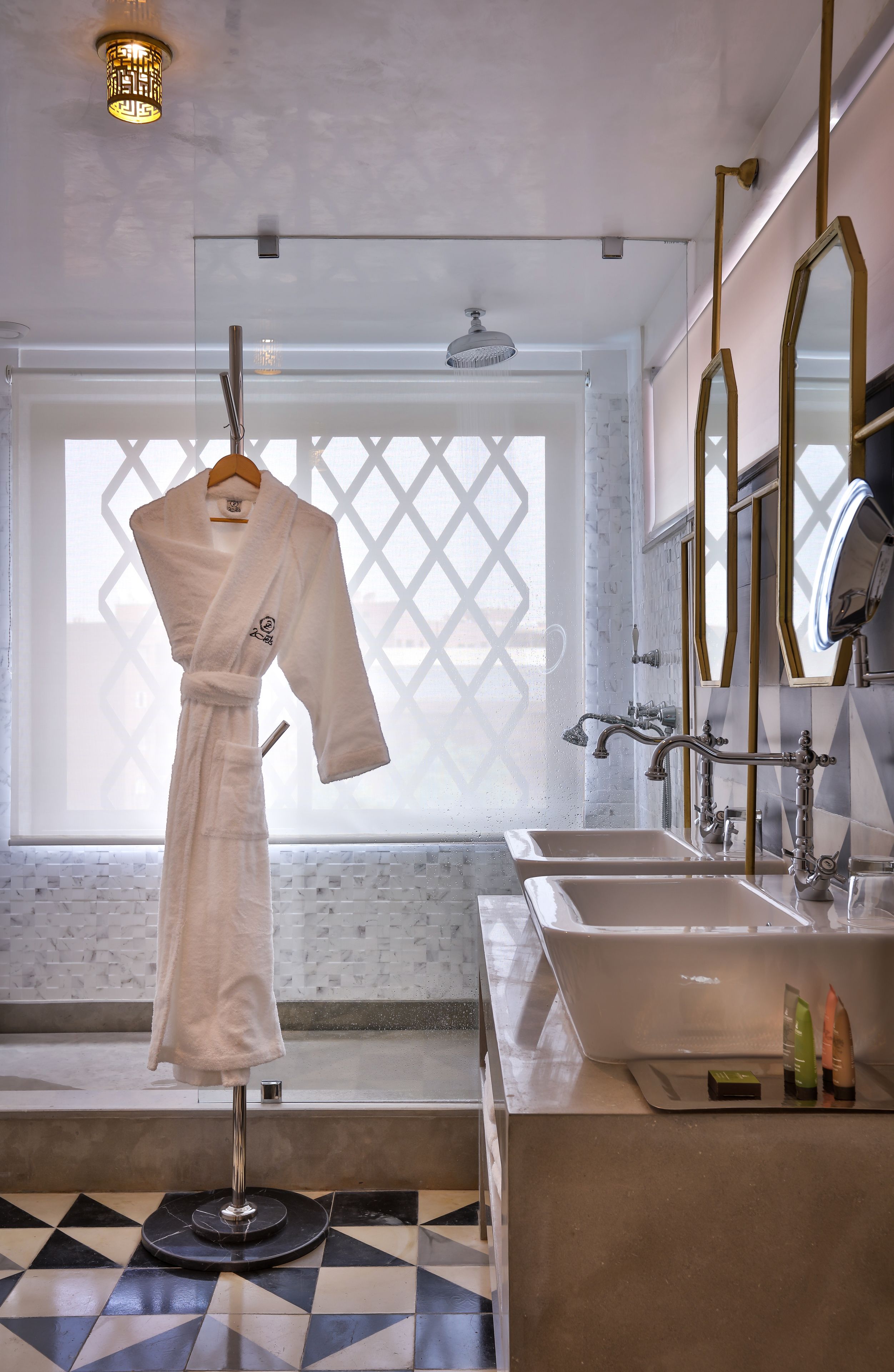 deluxe room | bathroom | shower, rainfall showerhead, designer toiletries, hair dryer