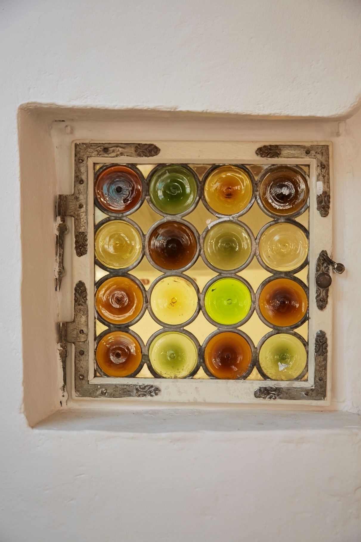 A window with a grid of colored glass panes.