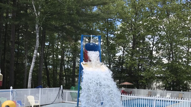 A public swimming pool with a water slide and a duck float. - Seabrook Inn (Seabrook)