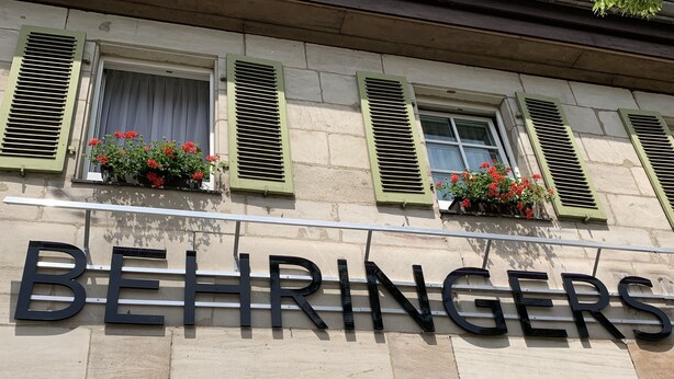 A building facade with the name "BEHRINGERS" prominently displayed.