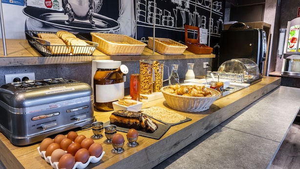 A breakfast buffet with various food items and a toaster. - ibis budget Villemomble (Villemomble)