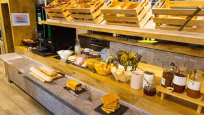 A bakery counter with various baked goods, a coffee machine, and condiments.