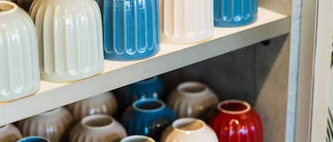 A shelf with various ceramic vases in different shapes and sizes.