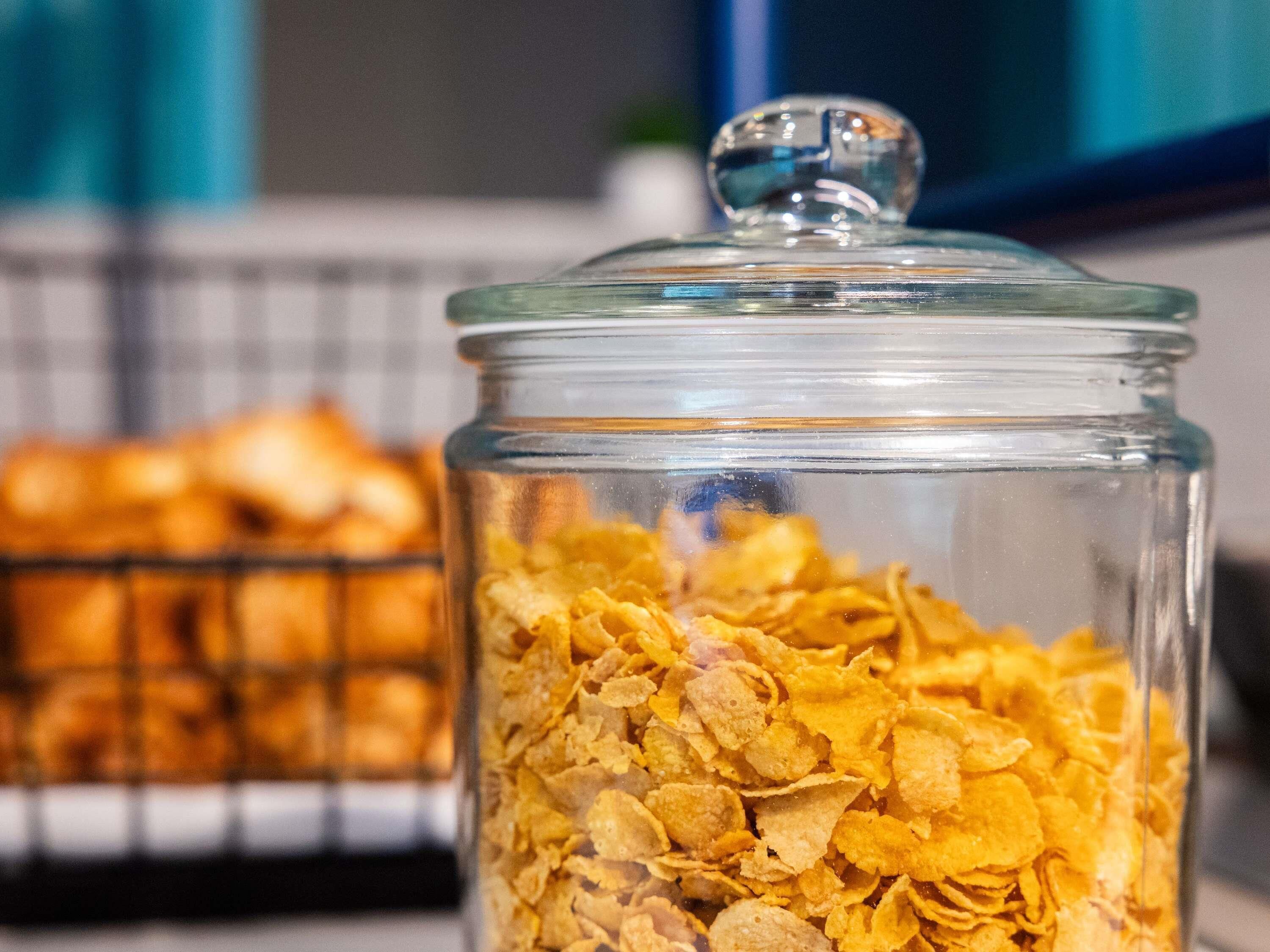 A glass jar filled with cereal flakes.