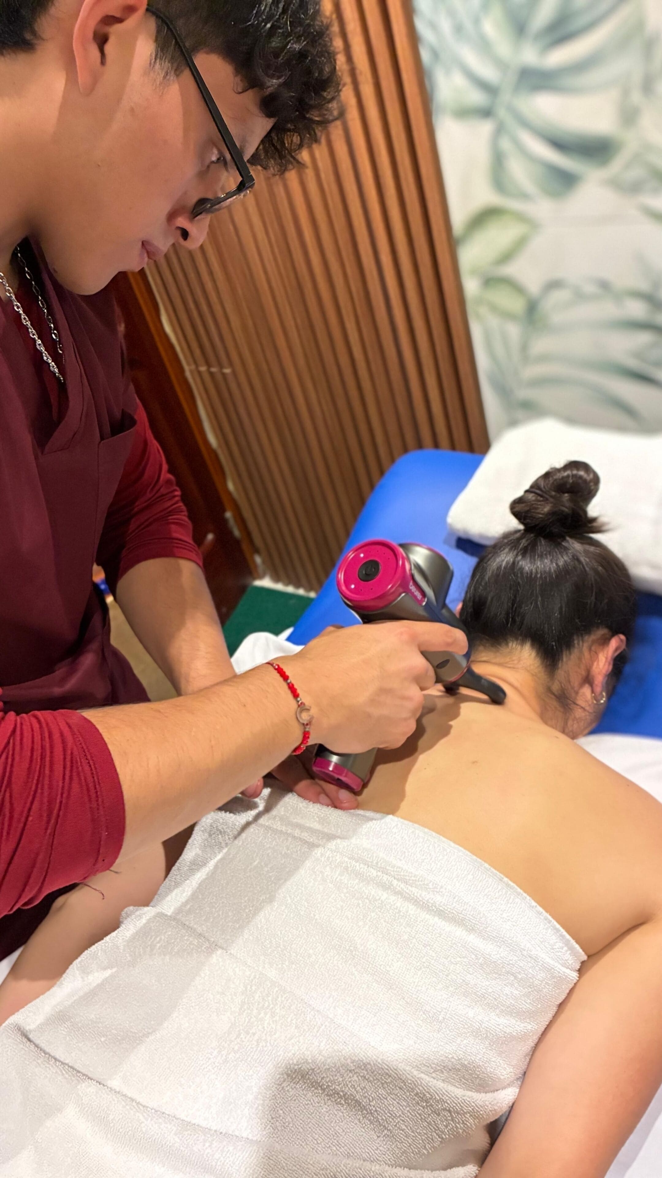 A person receiving a facial treatment with a handheld device.