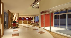 A modern hotel lobby with a reception desk, seating area, and large glass doors leading outside. - ibis Hyderabad Hitech City Hotel (Hyderabad)