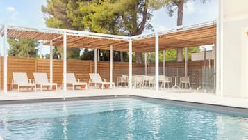 Seasonal outdoor pool, open 9:00 AM to 8:00 PM, pool umbrellas