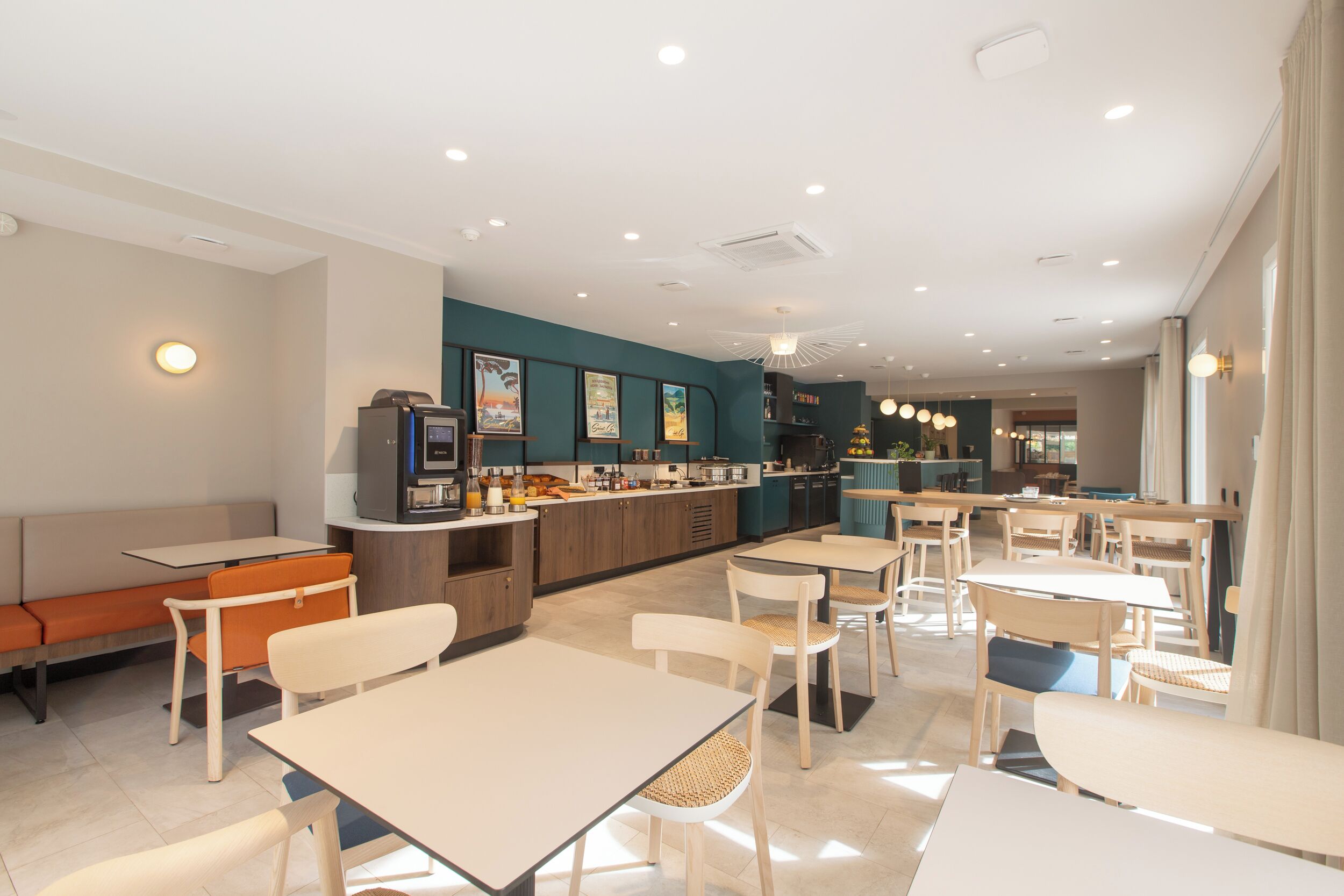 A modern restaurant with a bar area, seating arrangements, and a kitchen visible in the background.