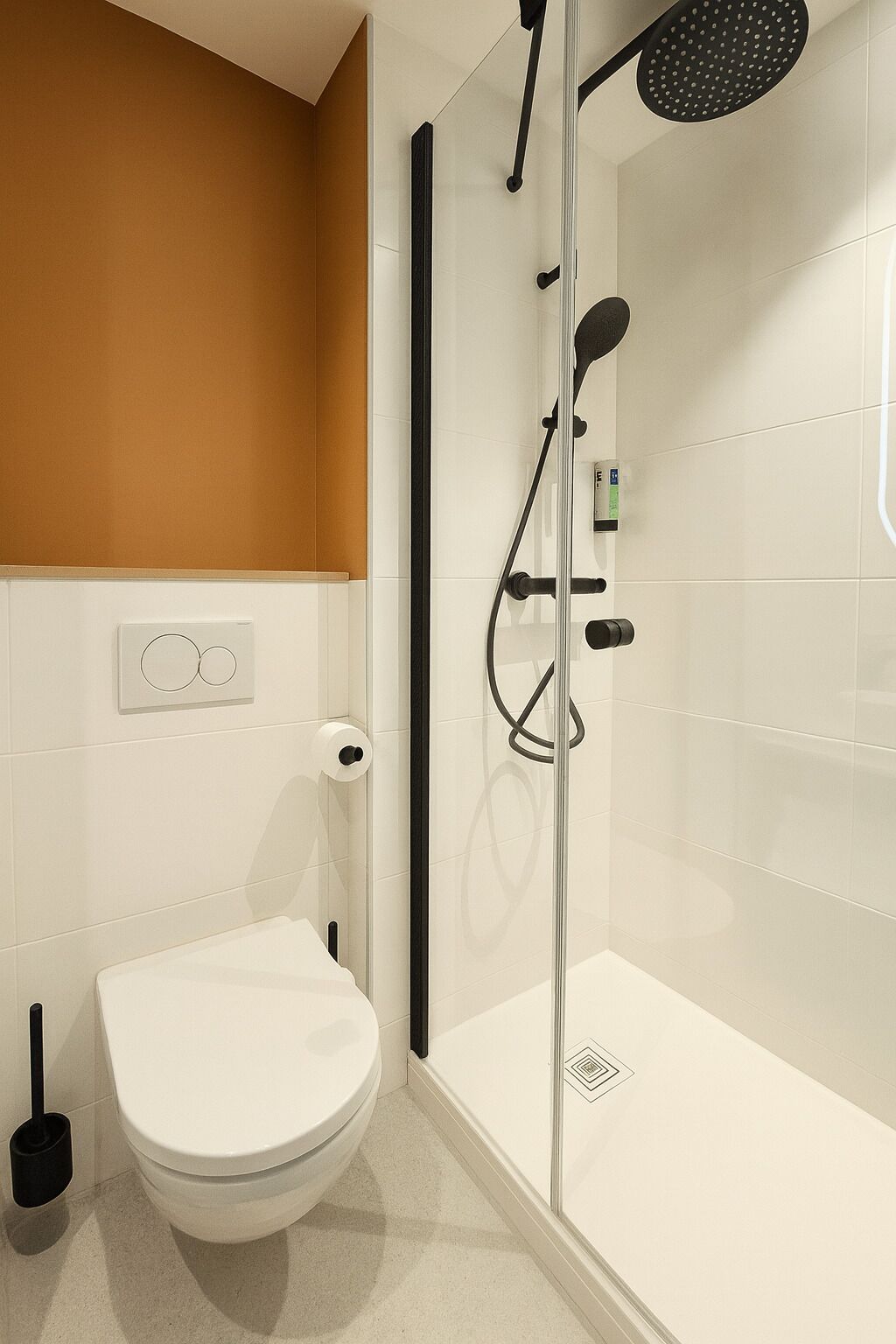 Ein modernes Badezimmer mit einer Duschkabine, einer Toilette und einem Bidet.
