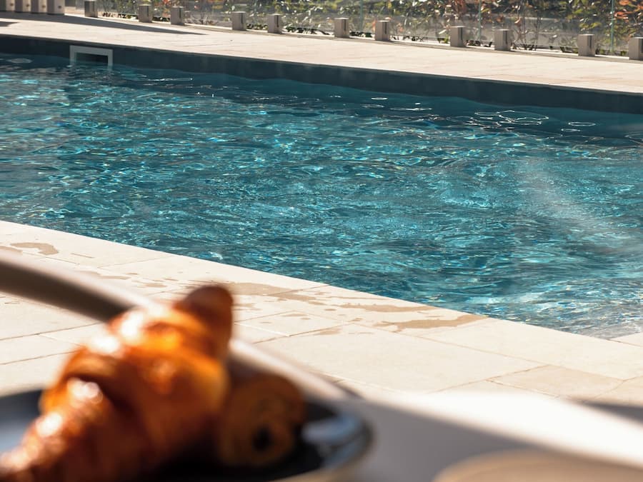 Seasonal outdoor pool, open 9:00 AM to 8:00 PM, pool umbrellas