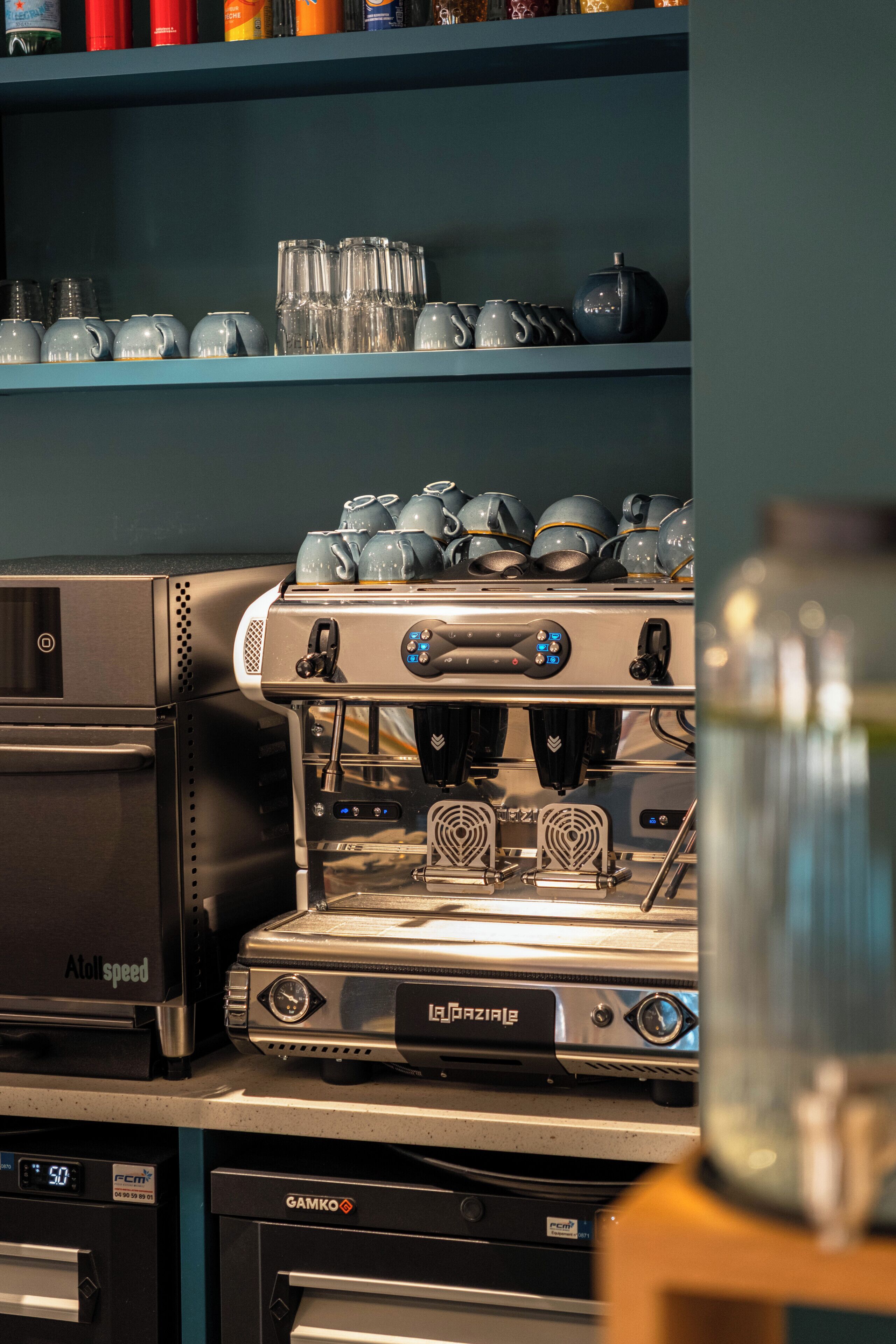 A coffee machine with a digital display, a water dispenser, and a coffee grinder.