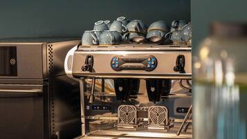 A coffee machine with a digital display, a water dispenser, and a coffee grinder.