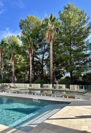 Seasonal outdoor pool, open 9:00 AM to 8:00 PM, pool umbrellas