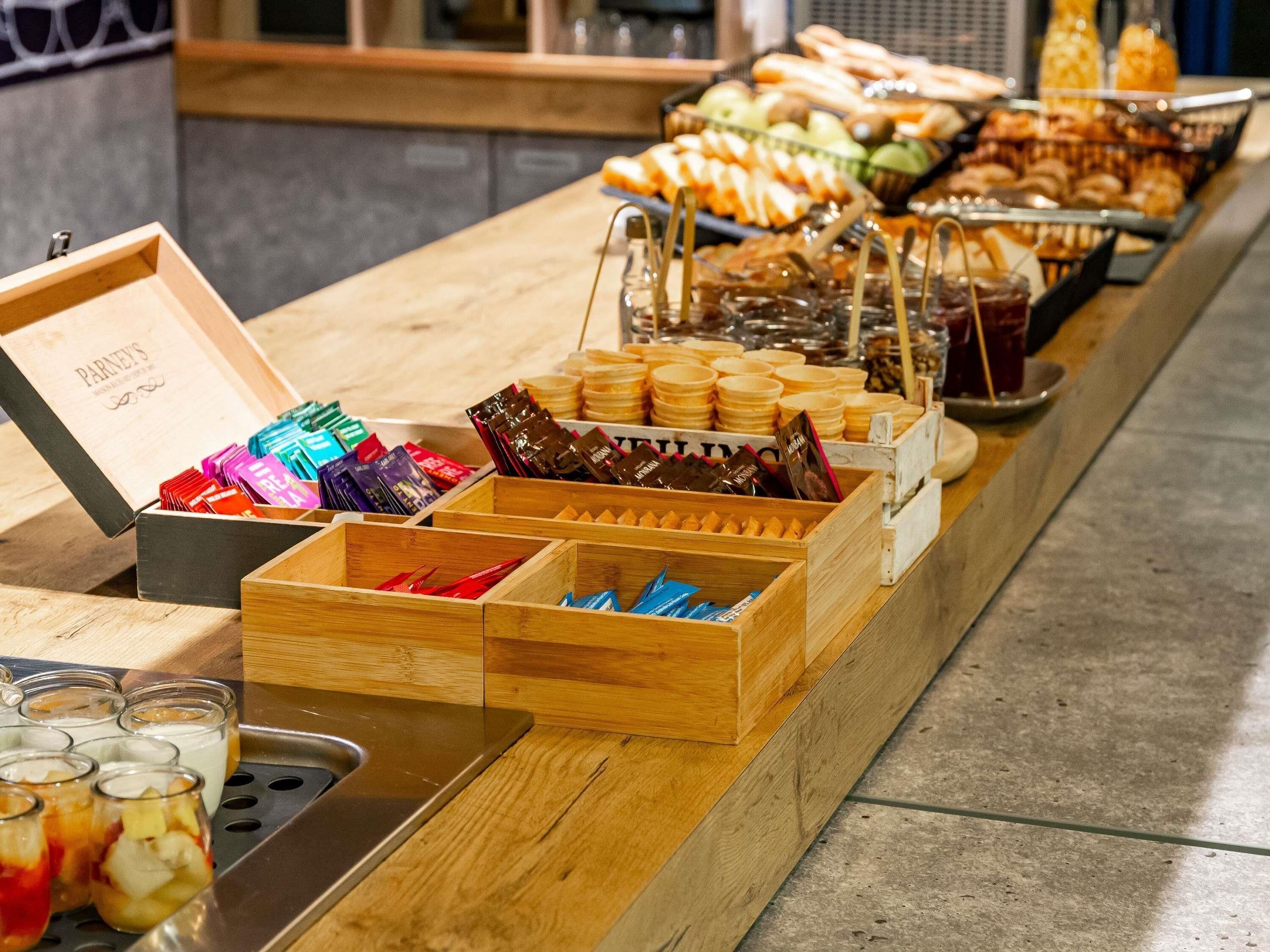 A buffet with various food items and containers.