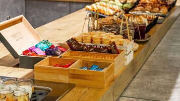 A buffet with various food items and containers.