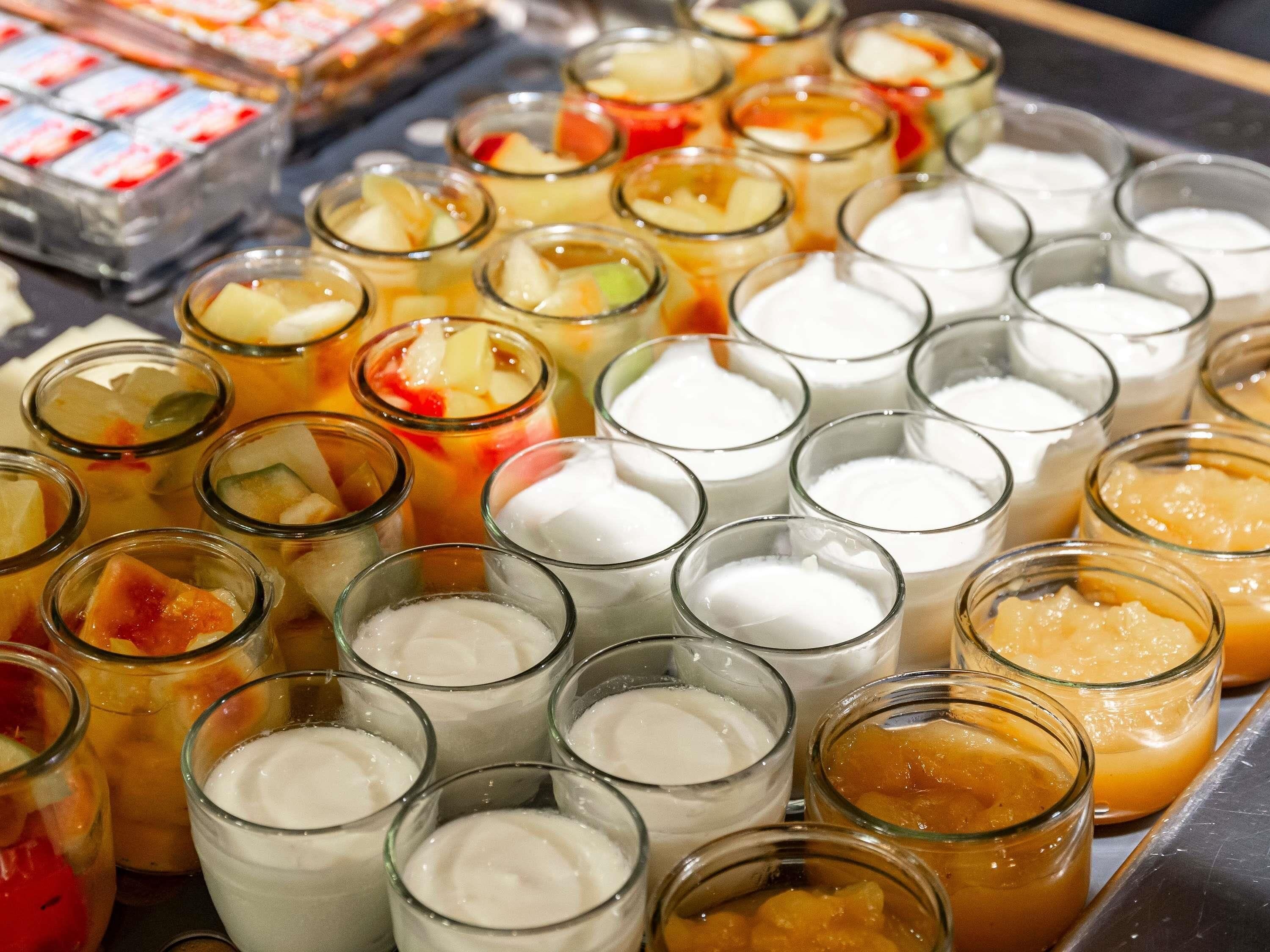 A variety of beverages in small glasses, including fruit-infused drinks and milkshakes.