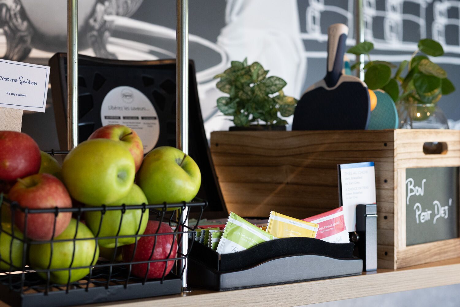 A fruit display with apples and a chalkboard sign.