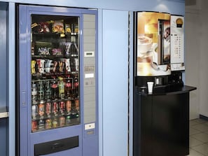 A vending machine with a beverage dispenser and a snack vending machine. - ibis budget Nuits Saint Georges (Nuits-Saint-Georges)