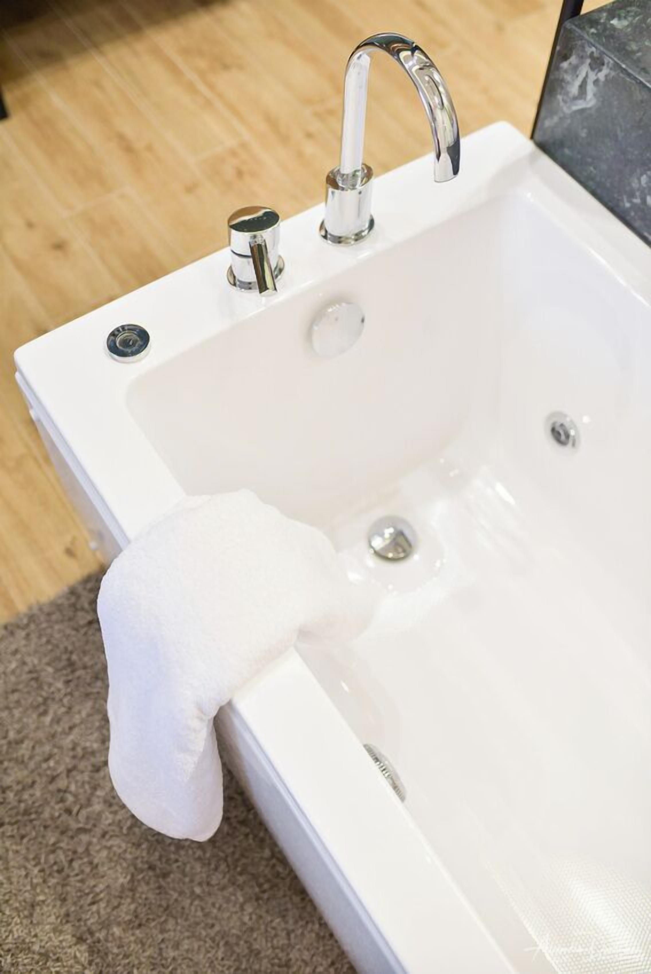 A white bathtub with a modern faucet and a single control knob.