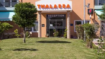 A building with a reception area labeled 'THALASSA'.