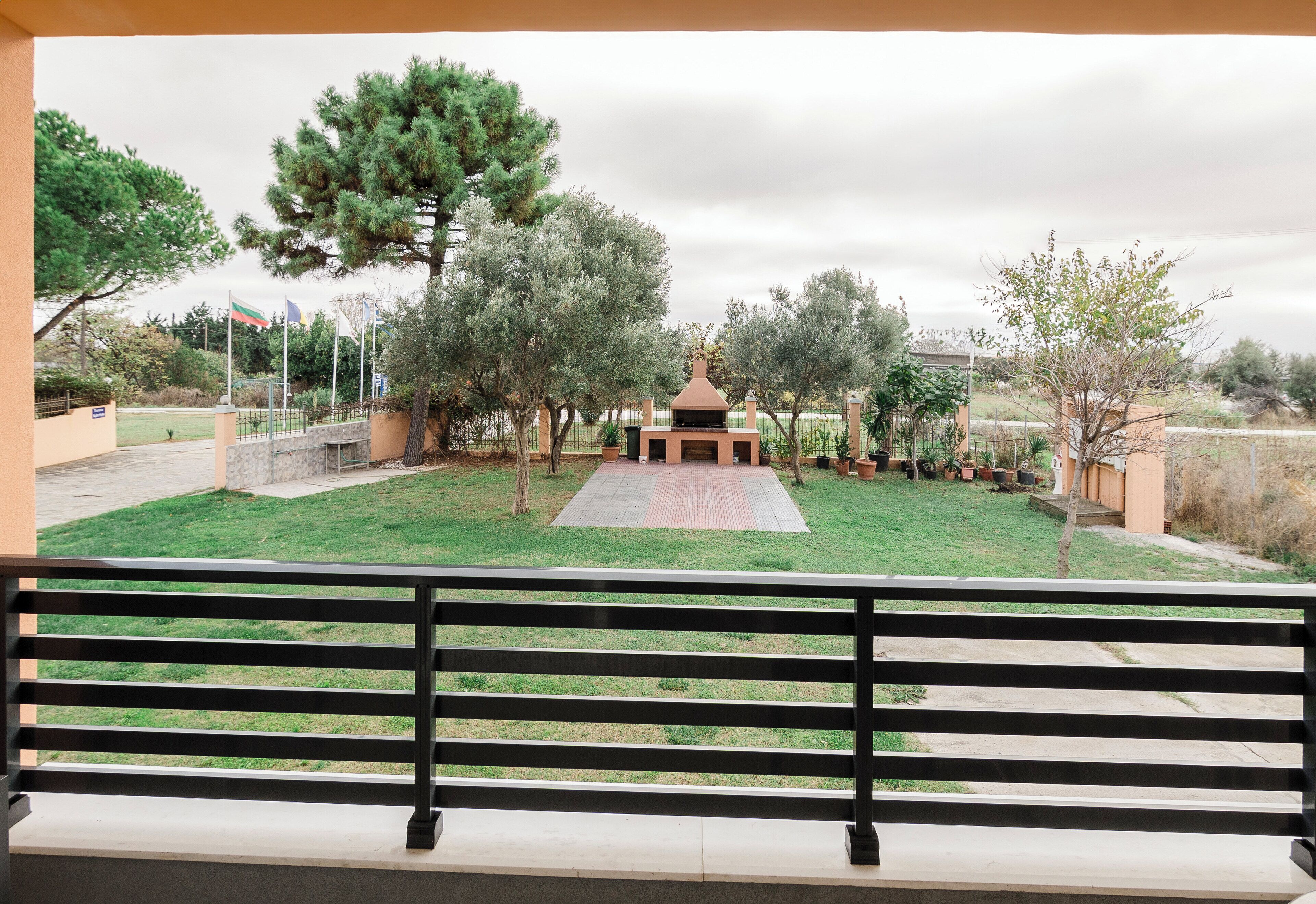 A park with a gazebo, trees, and a paved walkway.